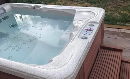 Old hot tub being dismantled and removed from a Palm Beach Gardens backyard